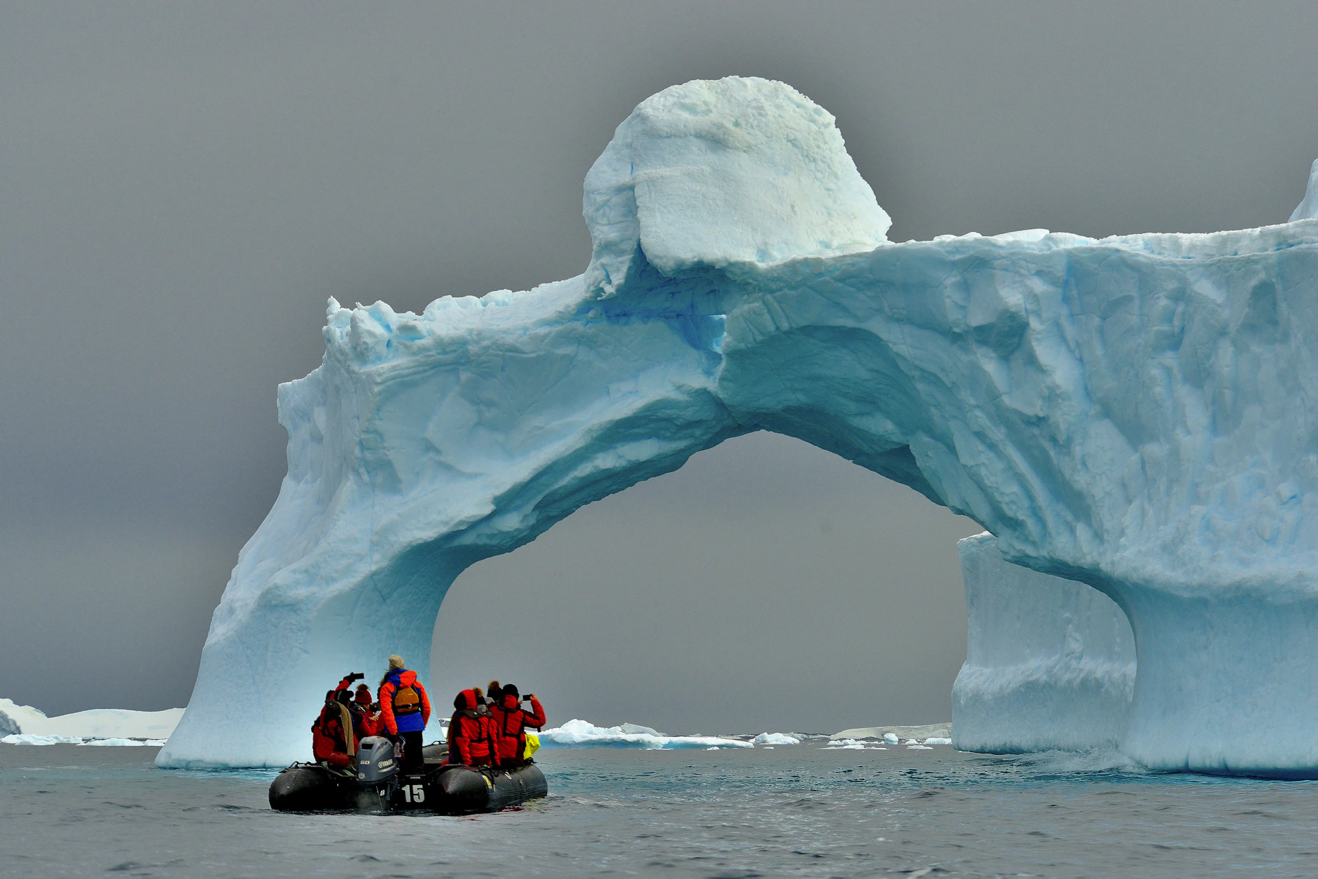 people sitting on ice formation during daytime