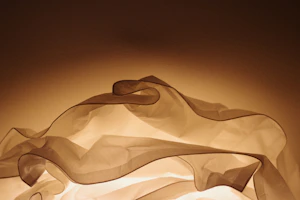 Elegant display of folded garments with poetic light and shadow interplay
