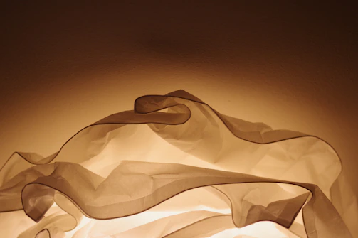 Elegant display of folded garments with poetic light and shadow interplay
