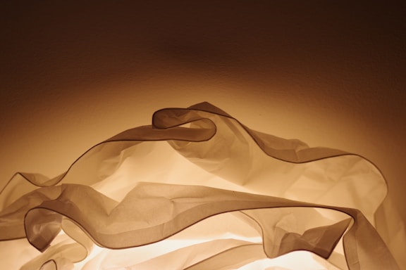 Soft natural light filtering through translucent crystals on a beige fabric background.