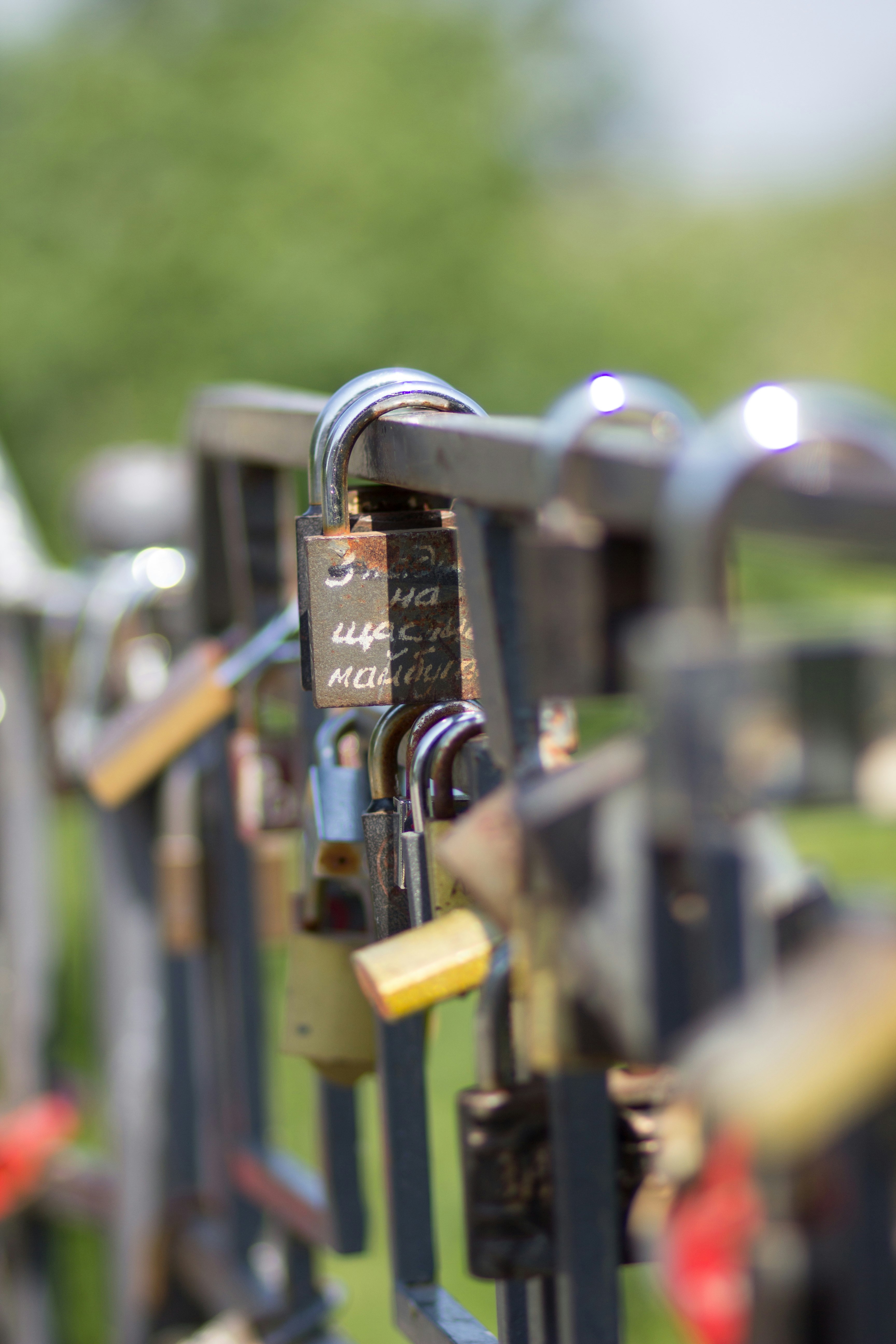 padlock on black metal fence during daytime