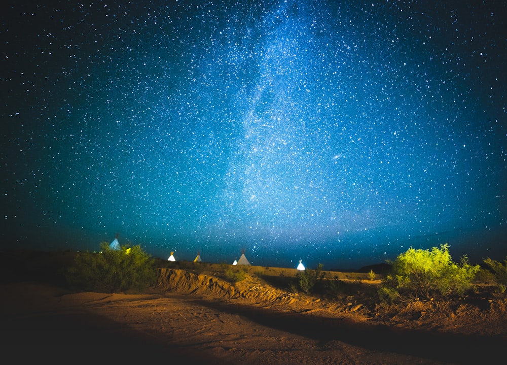 brown sand under blue sky during night time