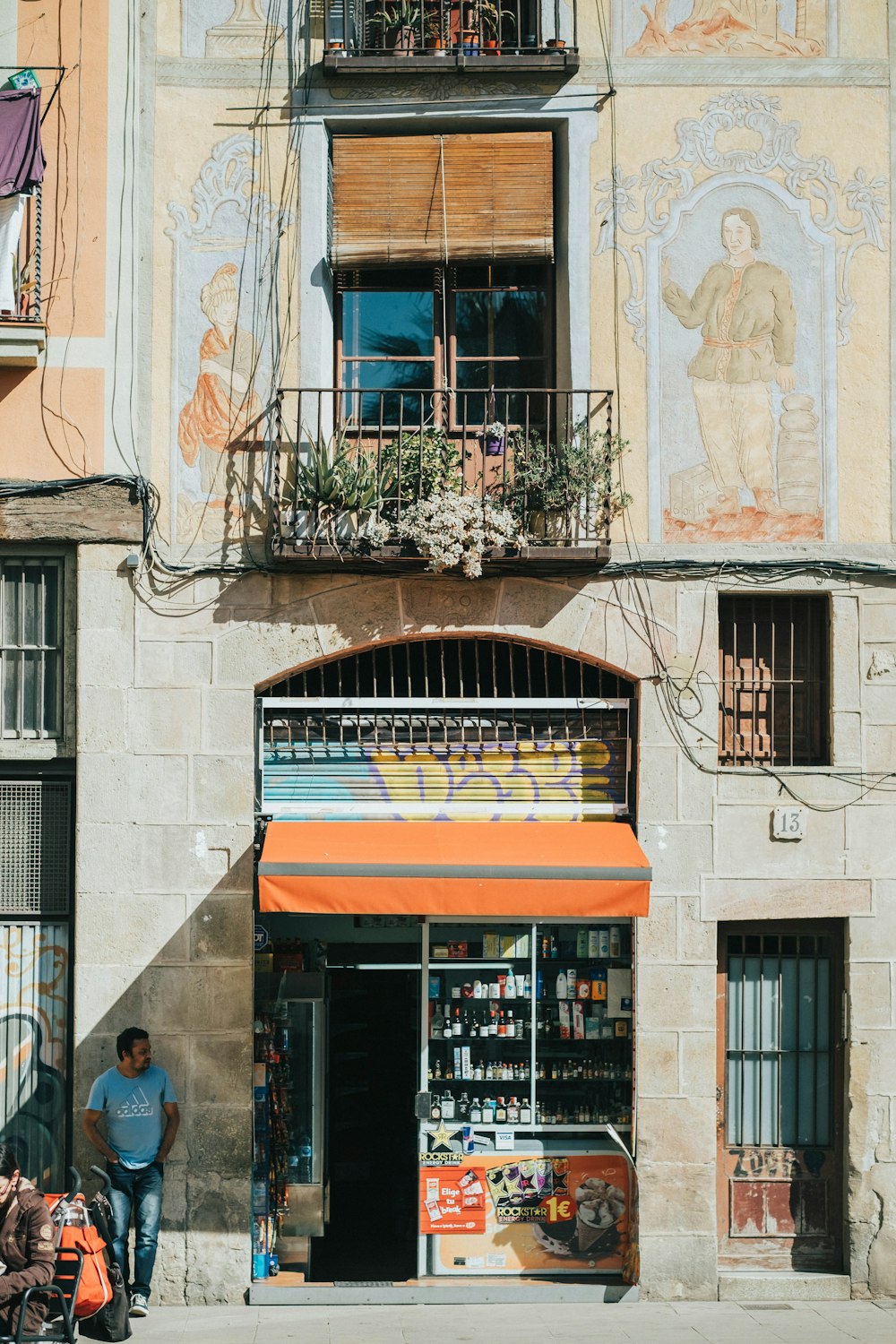 people walking on sidewalk near building during daytime