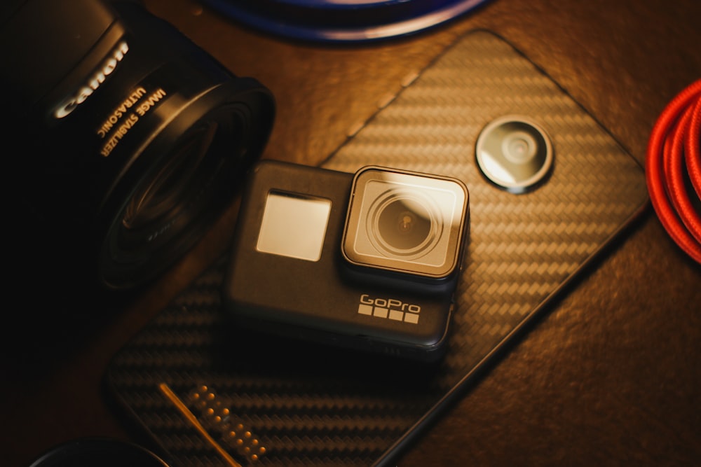 black sony camera on brown wooden table