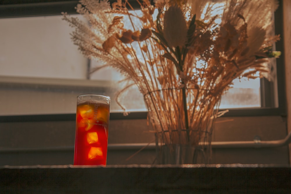 clear drinking glass with red liquid inside