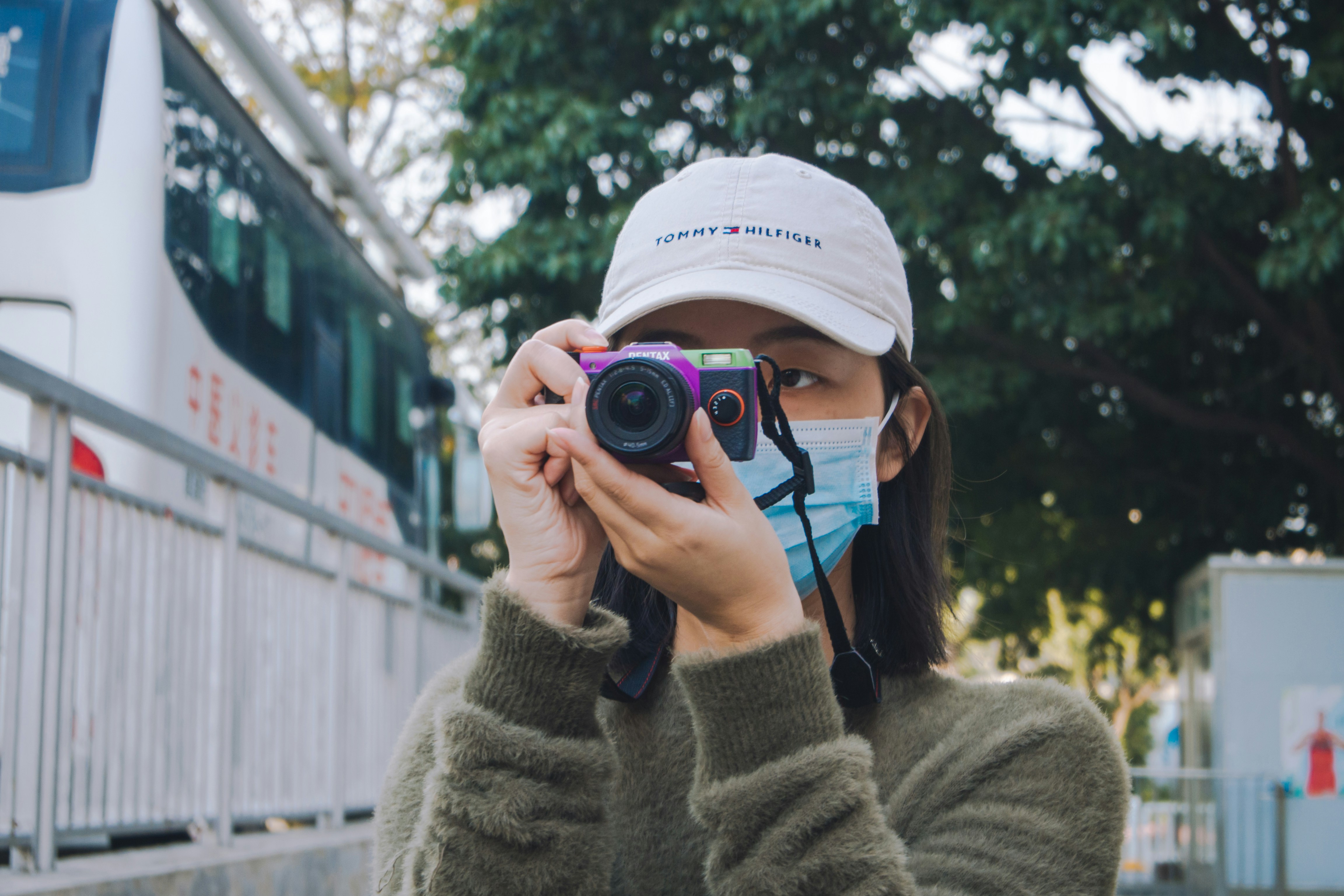 woman in beige knit sweater holding black nikon dslr camera