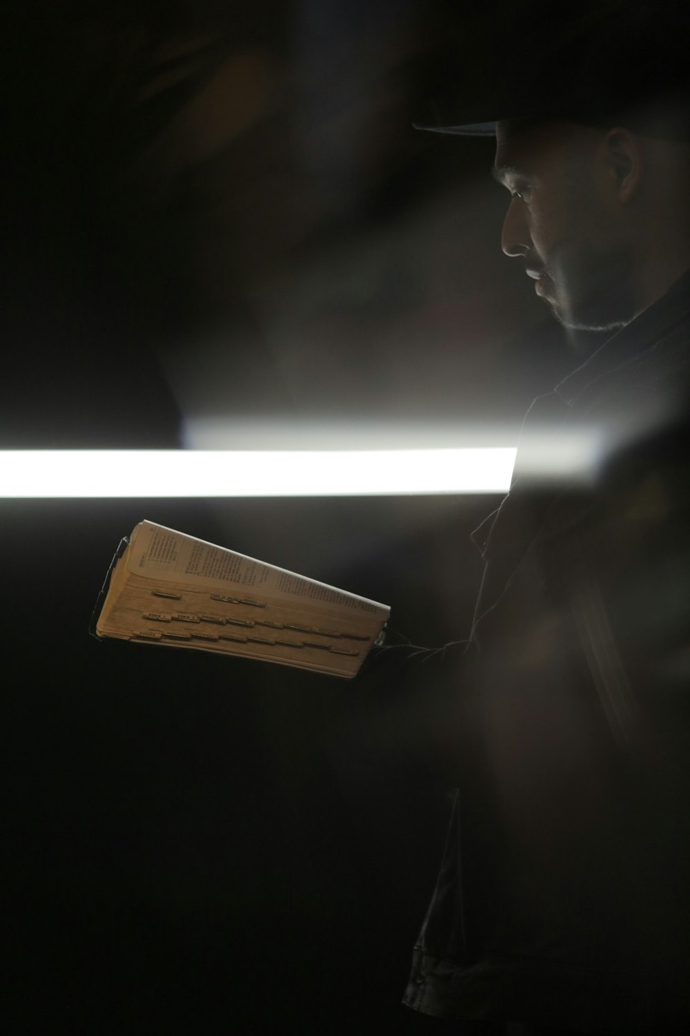 man in black shirt holding brown wooden board