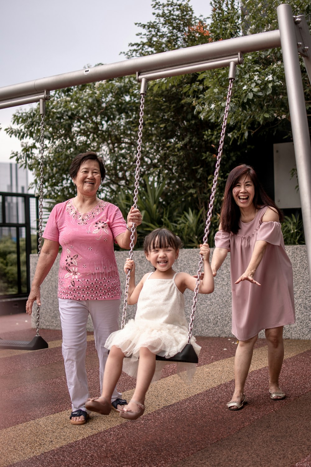 2 girls sitting on swing