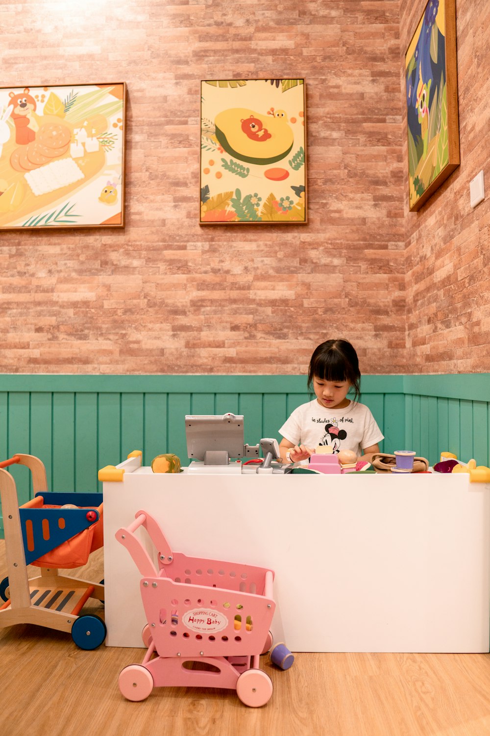 girl in white long sleeve shirt sitting on pink chair