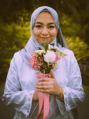 Bright spring ensemble with a floral maxi dress paired with a light hijab and denim jacket.
