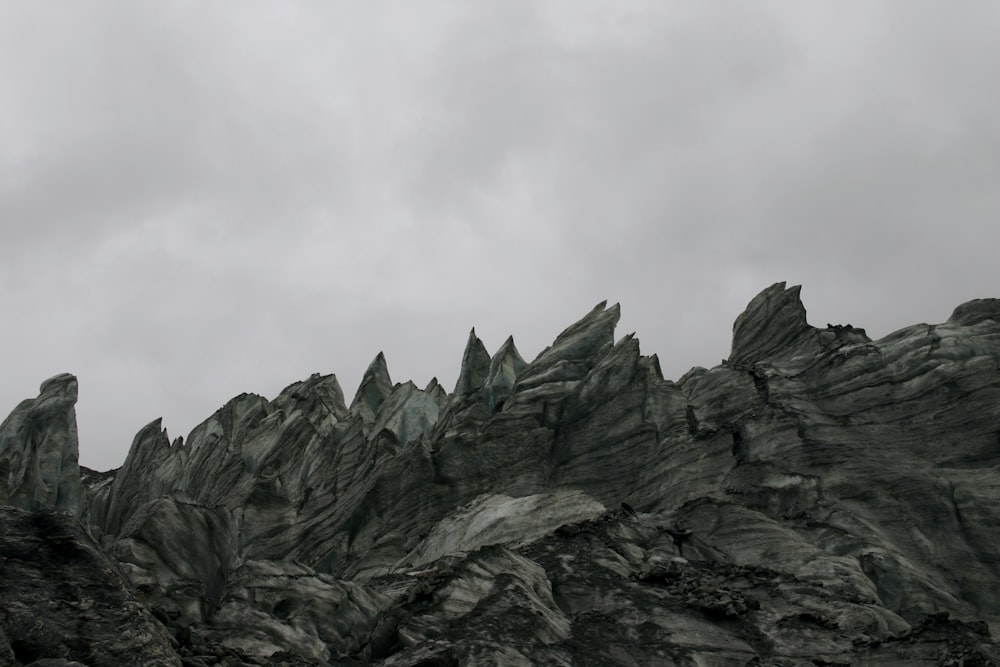 gray rocky mountain under white cloudy sky during daytime