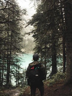 A serene outdoor setting with a person using survival gear in nature.