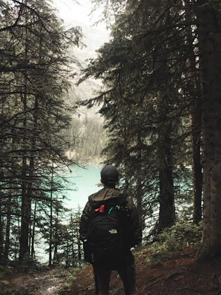 A serene outdoor setting with a person using survival gear in nature.