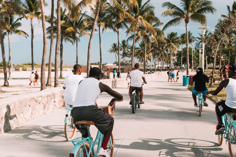 man in white t-shirt riding on bicycle during daytime