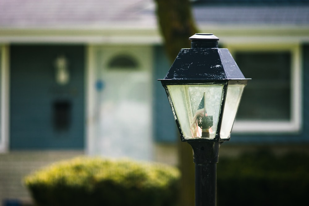 black lamp post near white house during daytime
