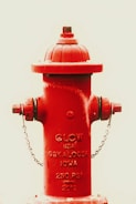a red fire hydrant with a chain around it
