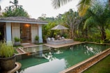 white and brown house near swimming pool during daytime