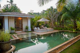 white and brown house near swimming pool during daytime