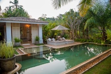 white and brown house near swimming pool during daytime