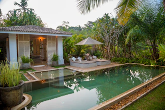 white and brown house near swimming pool during daytime