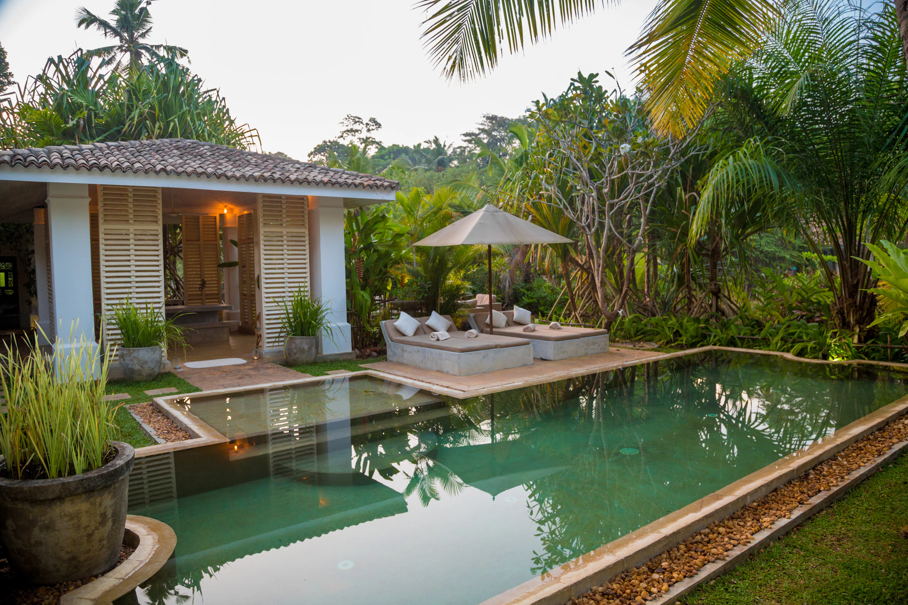 A long lap pool beside a desert villa at golden hour