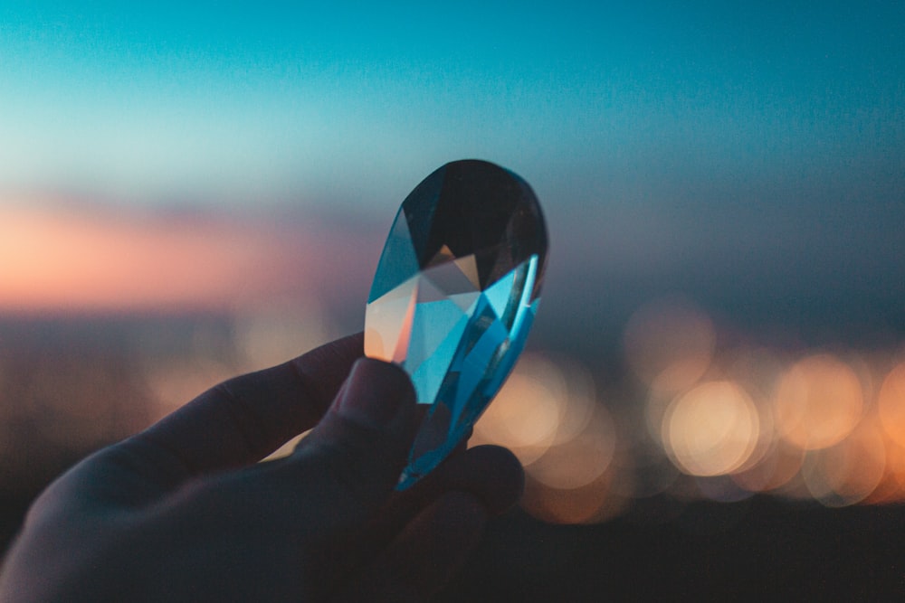 person holding heart shaped glass