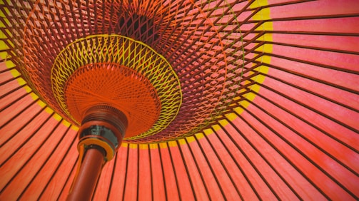 pink and yellow umbrella on brown wooden table