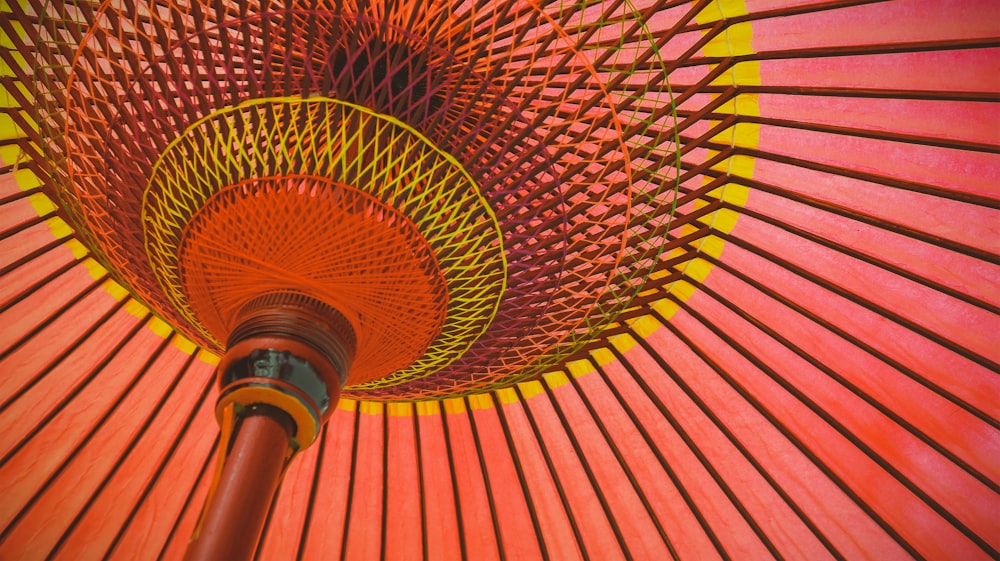 pink and yellow umbrella on brown wooden table