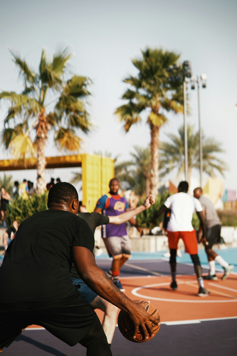 man in black t-shirt and white shorts running on track field during daytime