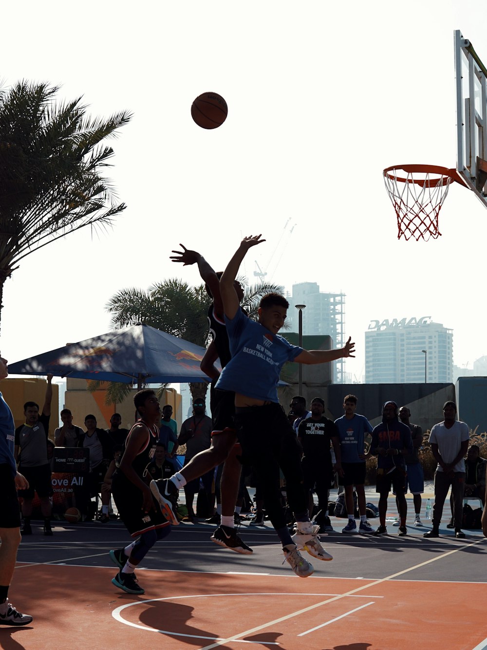 people playing basketball during daytime