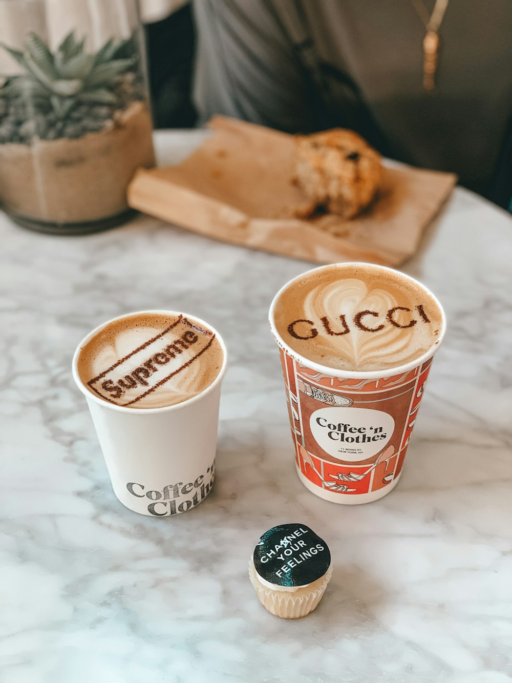 white and red disposable cup beside brown bread