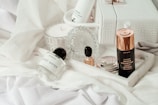 white and brown plastic bottle on white textile