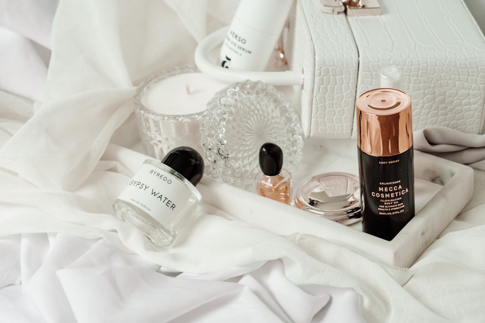 white and brown plastic bottle on white textile