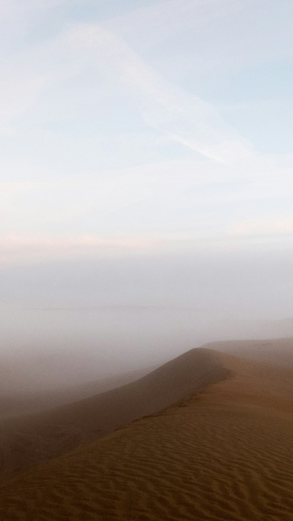 brown mountains under white clouds during daytime