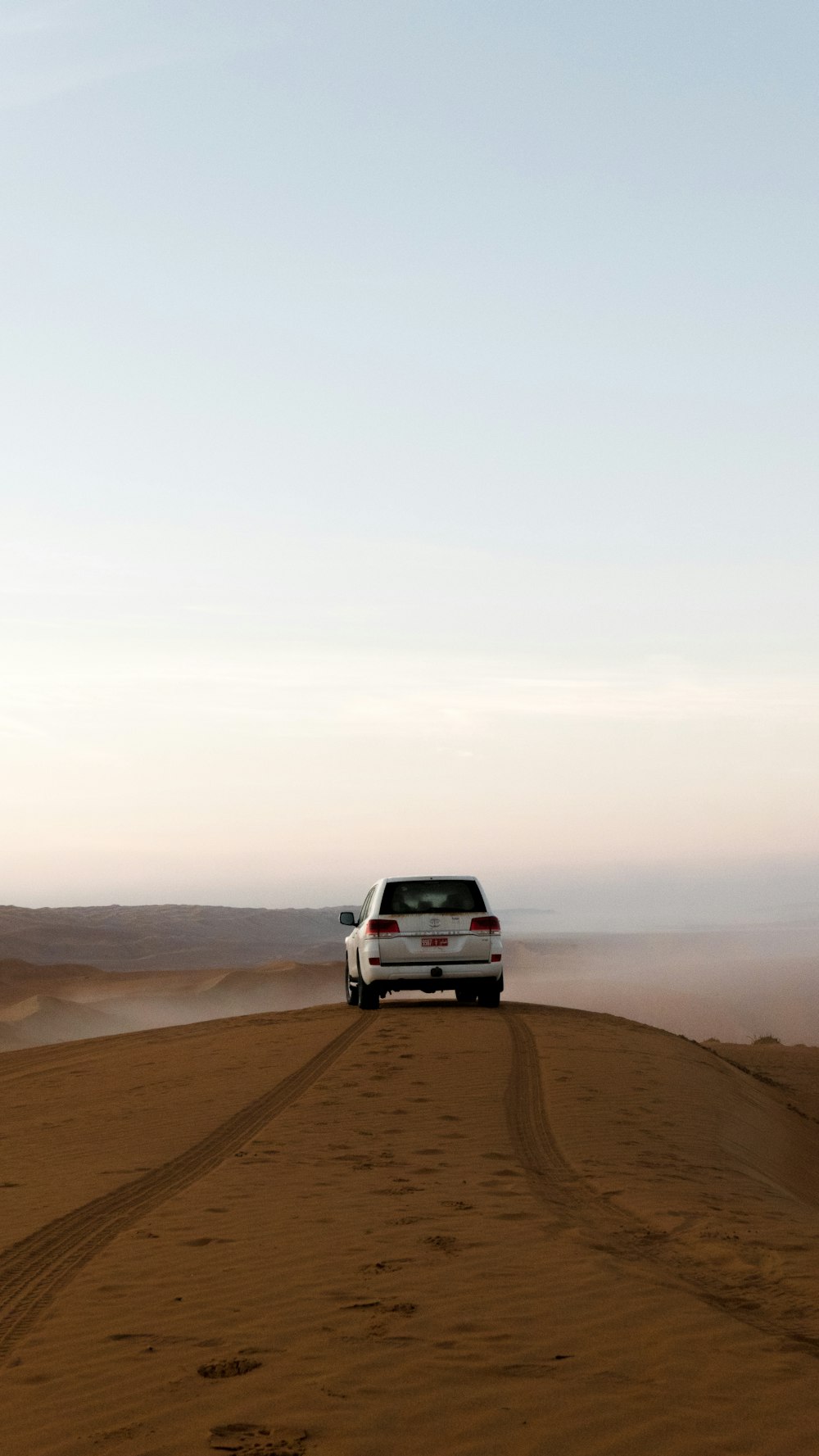 white suv on brown sand