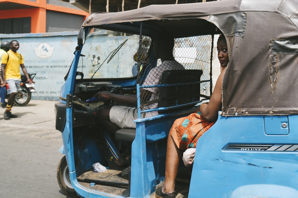 woman in blue and black car