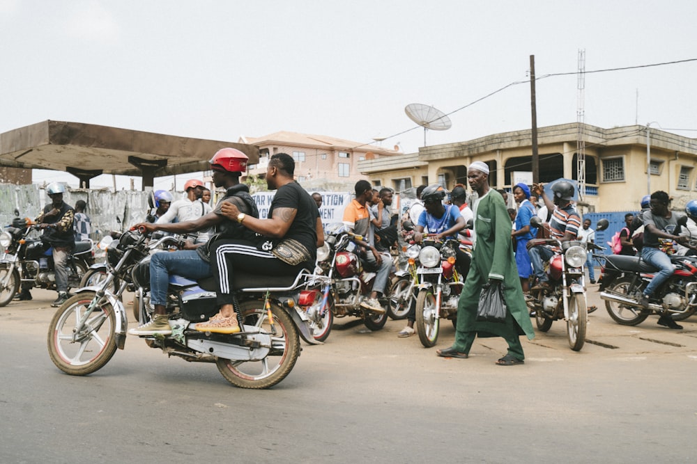 people riding on motorcycle during daytime