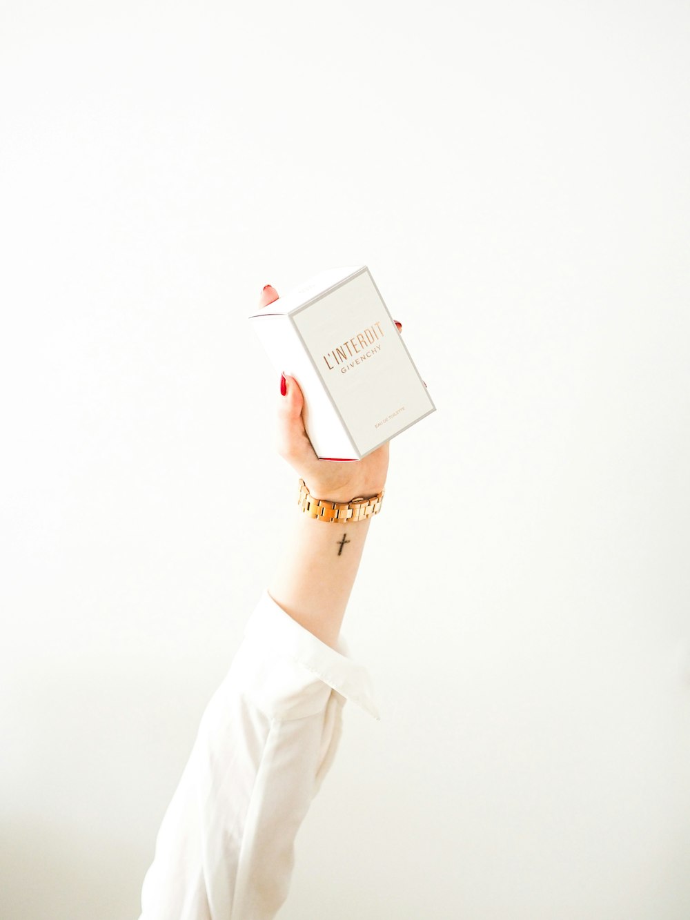 person in white dress shirt holding white book