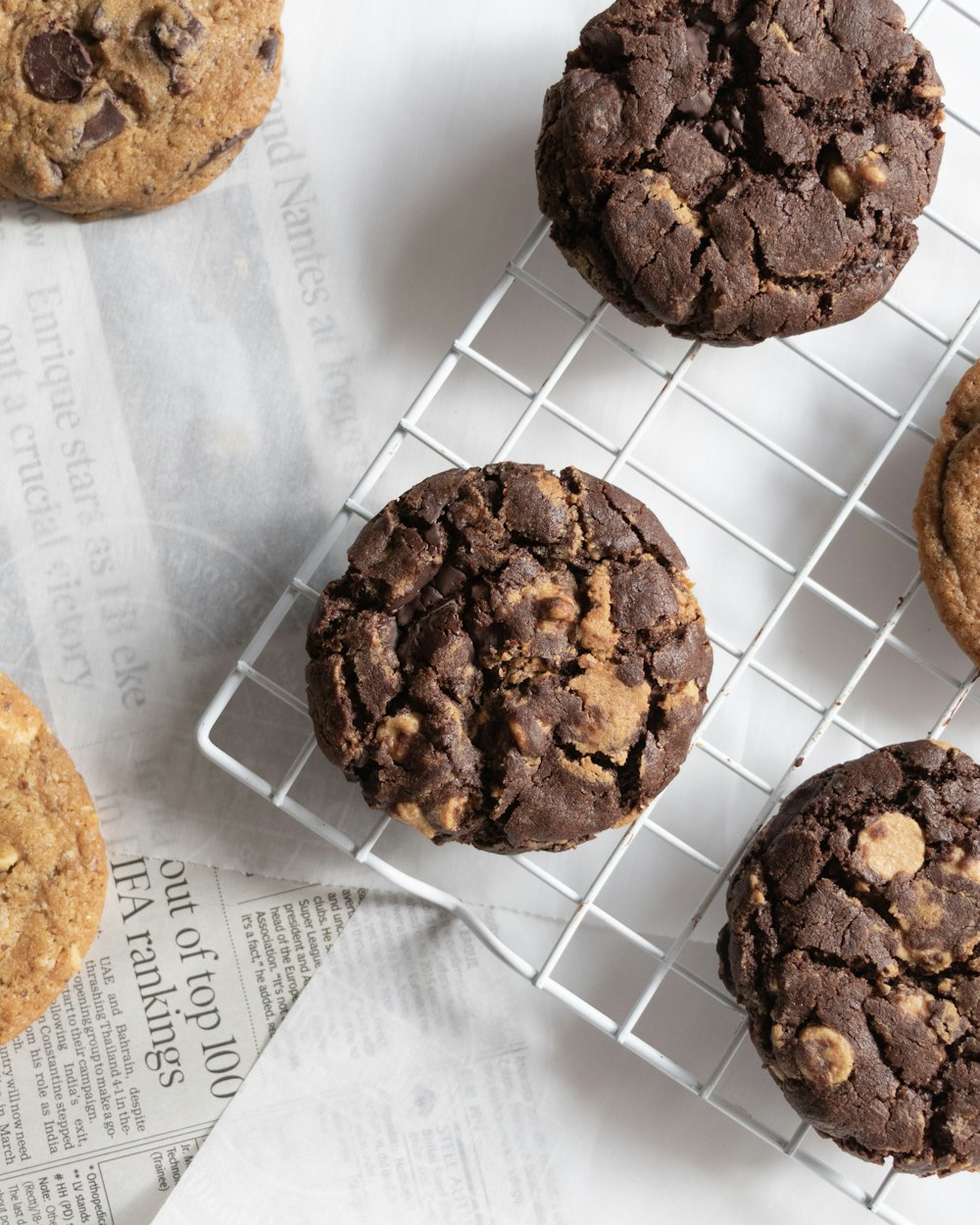 a bunch of cookies sitting on top of a metal rack