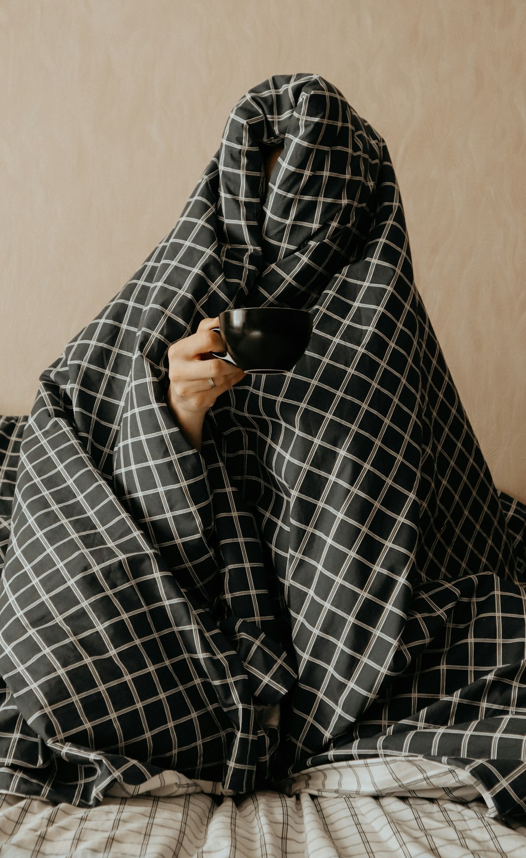 person in black and white checkered long sleeve shirt