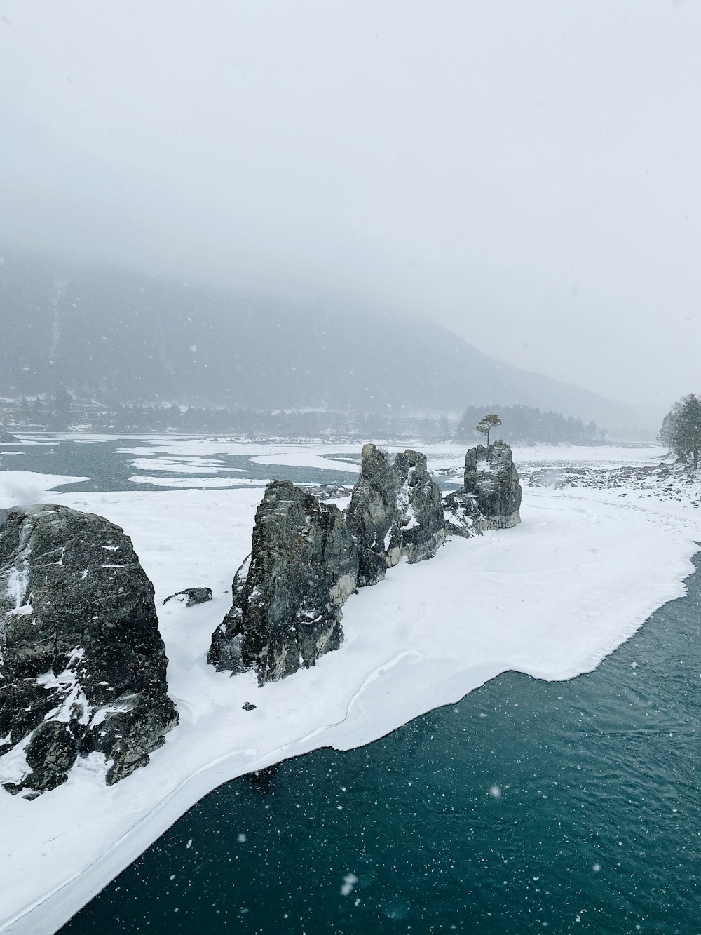 gray rock formation on snow covered ground during daytime