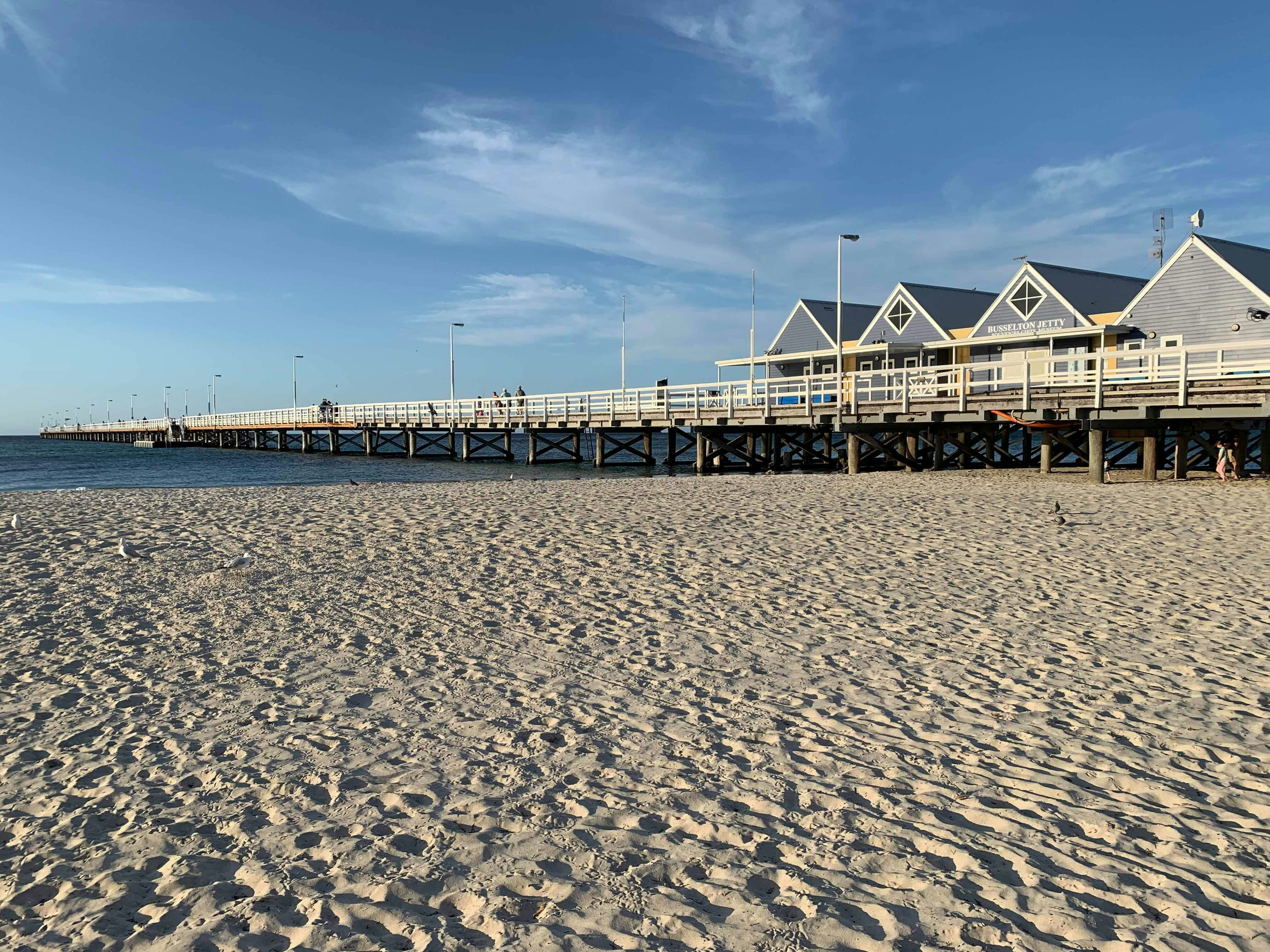 brown wooden dock on sea under blue sky during daytime