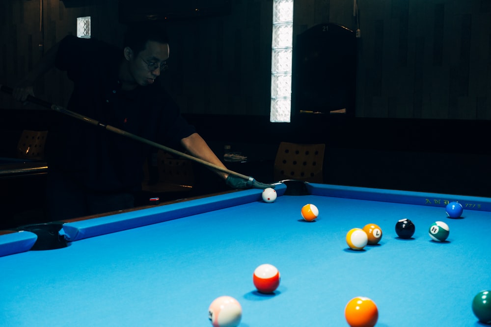 man in black jacket playing billiard