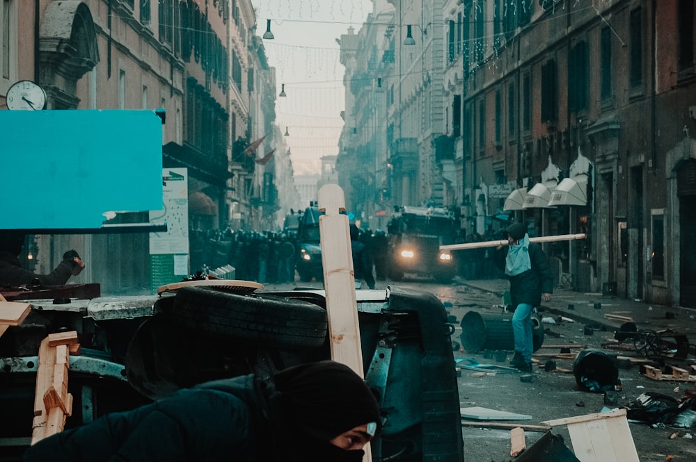 man in black jacket standing on sidewalk during daytime