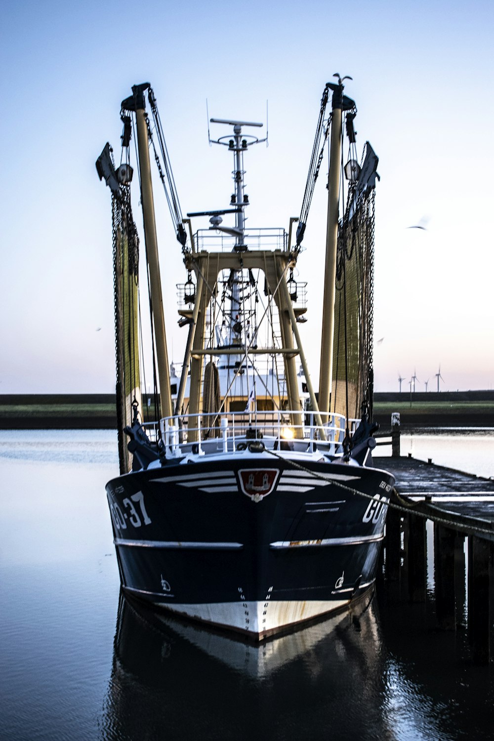 Schwarzes und braunes Boot tagsüber am Dock