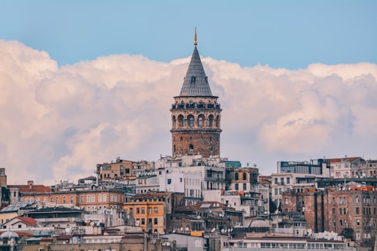 brown and white concrete building under blue sky during daytime in Galata Tower Turkey