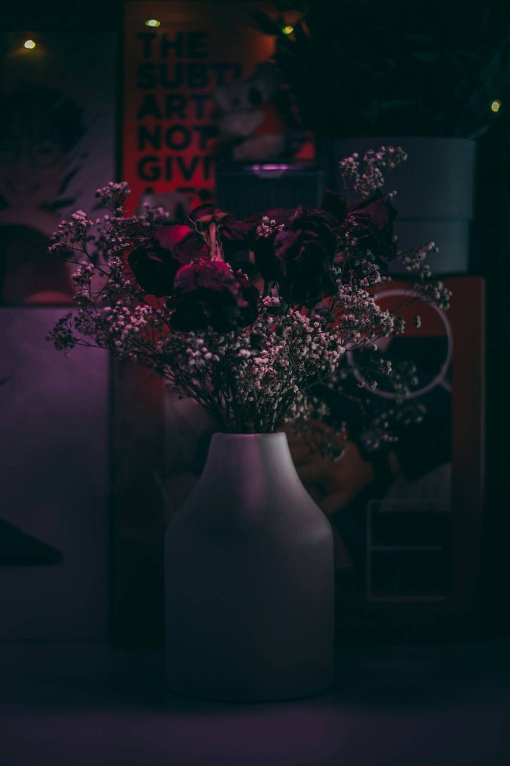 red flowers in white vase