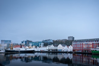 white and red concrete building near body of water during daytime
