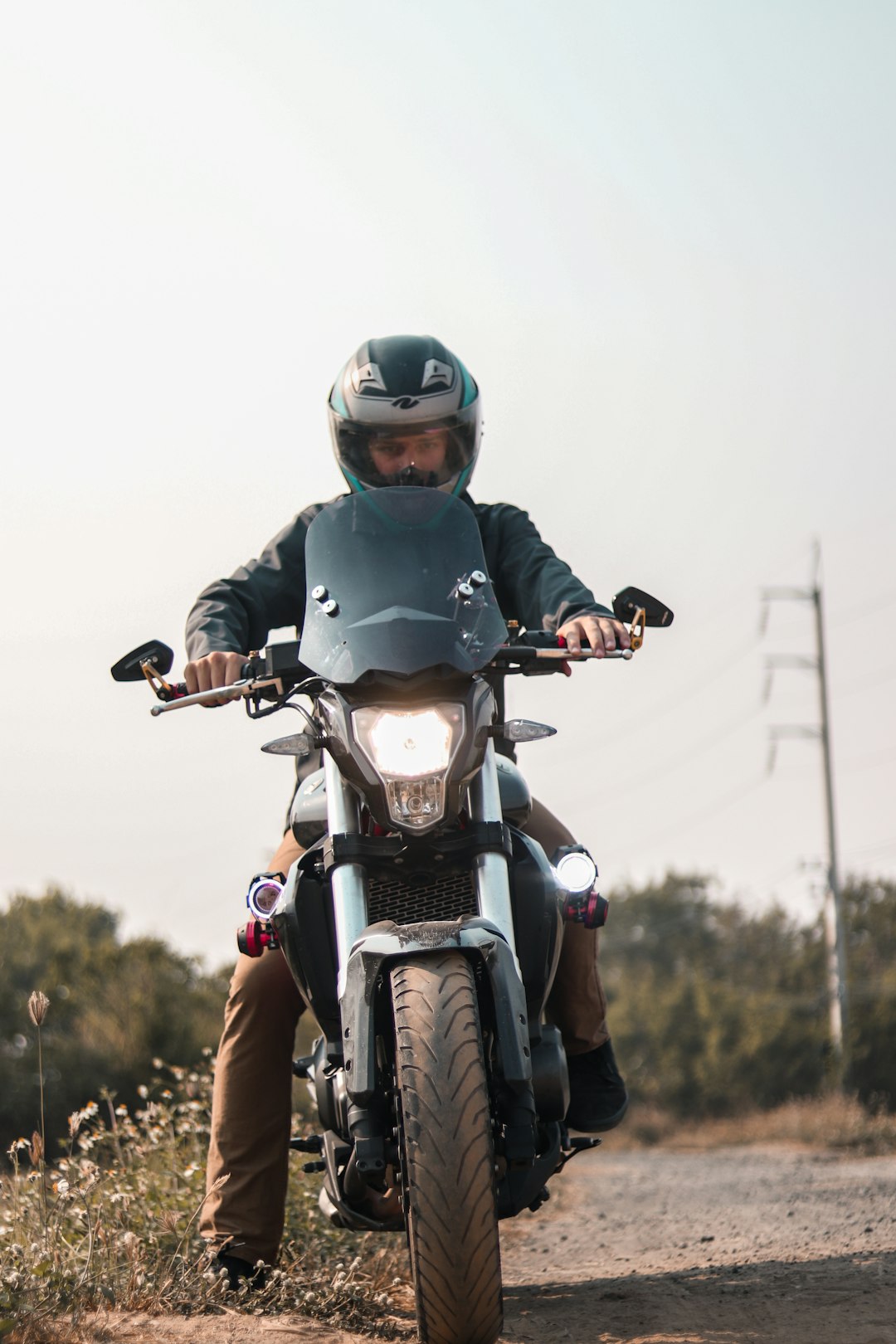 man in green helmet riding motorcycle