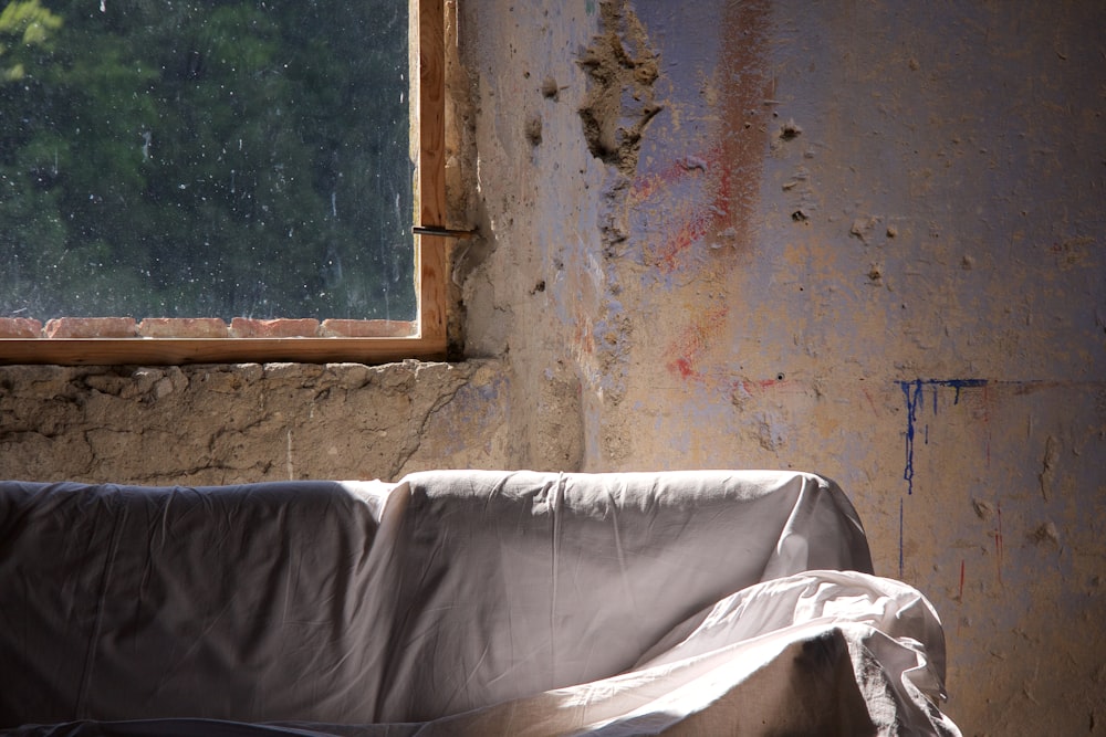 white textile on brown wooden window